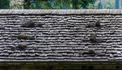 Roof covered by weather-beaten sliced wooden shingles