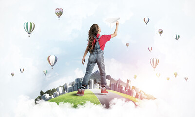 Fototapeta premium Concept of careless happy childhood with girl dreaming about future