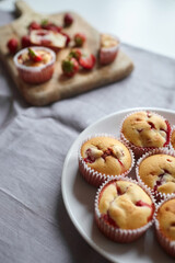 Homemade dessert - strawberry muffins on kitchen table background