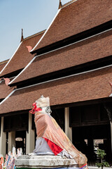 Old statue with ancient church of Prathat Lampang Luang temple
