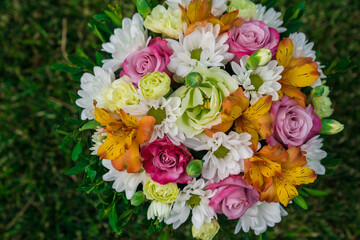 bouquet of colorful flowers on green lawn. 