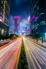 Fototapeta na wymiar Light trails and skyscrapers at night in Hong Kong