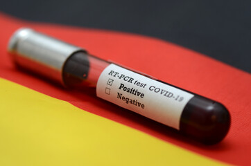 Stock photo of tube with Blood Test(novel Coronavirus 2019 disease,COVID-19,nCoV) on a flag of...