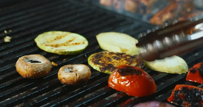 Making cooking grilled vegetables - champignons mushrooms, squash zucchini