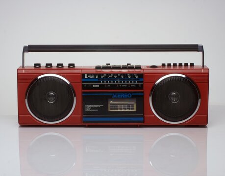 Vintage red boom box on white background with reflection