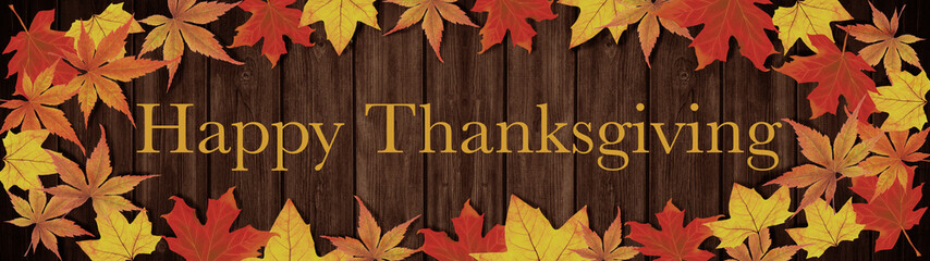 Happy Thanksgiving background banner panorama - Frame made of colorful fallen autumn leaves on brown rustic wooden wall / table texture, top view