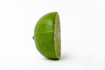 Bright juicy sour lime on a white background cut in half.