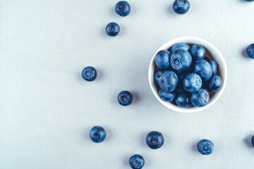 Fresh blueberries in a white bowl. Close up, top view.
