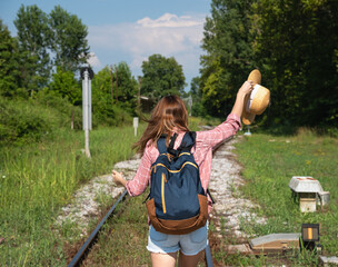 Woman traveler having fun at trains station. Local travel concept