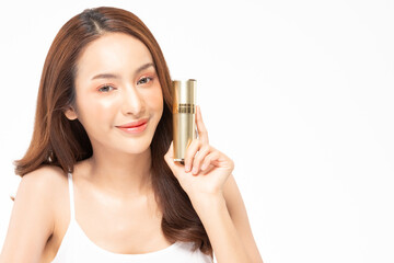 Fototapeta premium Beauty asian woman hold bottle cosmetic cream lotion and cheerful.