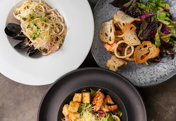 Different italian traditional dishes and salads on table.