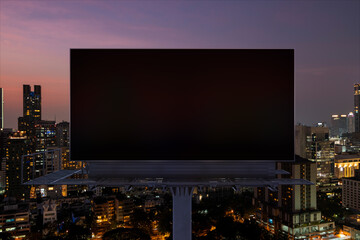 Blank black road billboard with Bangkok cityscape background at night time. Street advertising poster, mock up, 3D rendering. Front view. The concept of marketing communication to sell idea.