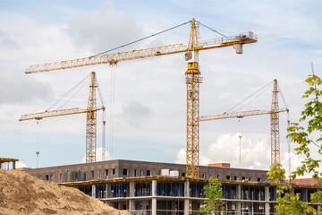 Group of tower crane on the construction of an apartment building. Construction site