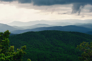 Rain over forest mountains. Misty mountain landscape hills at rainy day.