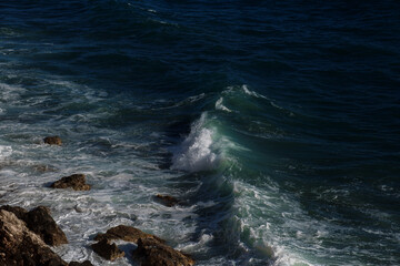 Ocean wave background breaking sea water rocky shore