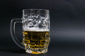 mug of beer on a dark background with nuts
