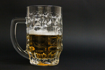 mug of beer on a dark background with nuts