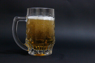 mug of beer on a dark background with nuts
