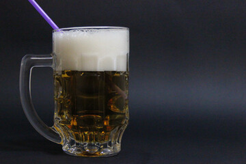 mug of beer on a dark background with nuts