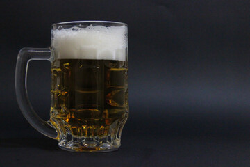 mug of beer on a dark background with nuts