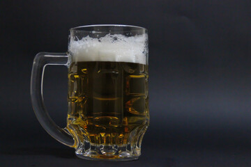 mug of beer on a dark background with nuts
