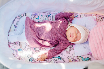 Obraz na płótnie Canvas Beautiful newborn baby girl sleeping on a blanket, sleeping newborn baby in a wrap.