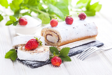 tasty strawberry dessert on a slate board on a white wooden table