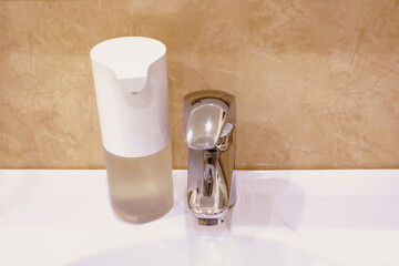 Automatic touchless foam foap dispenser in bathroom.