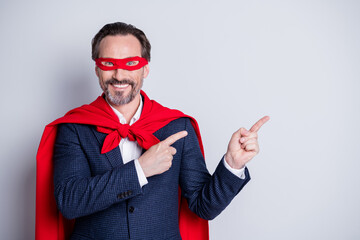 Photo of confident cheerful aged mature business guy super hero costume direct fingers side empty...