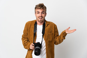 Young photographer blonde man isolated on white background with shocked facial expression