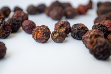 Dried cherries with bone inside on a white background scattered.