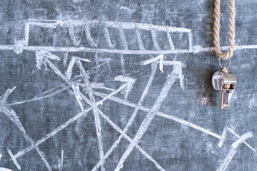 whistle of a soccer or football referee on black board with tactical whistle of a soccer or football referee on black board with tactical diagram, free copy space