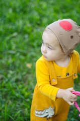 Photo of a blue-eyed toddler girl playing outside on the playground