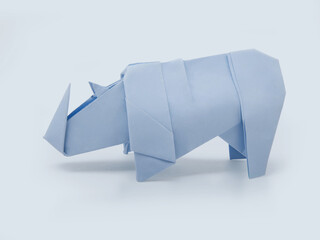 Origami cute rhinoceros on a blue background - 367473692