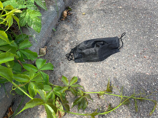 Used medical disposable masks lie on the ground during the Covid-19 pandemic.