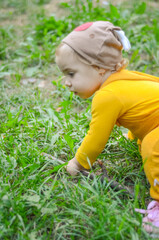 Photo of a blue-eyed toddler girl playing outside on the playground