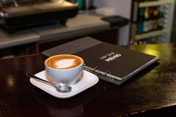 colorful bedspreads hang in the cupboard and the menu on the bar counter