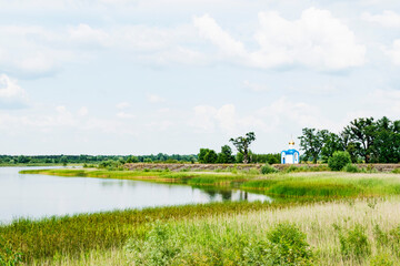 Naklejka premium A small Church on the shore of the lake