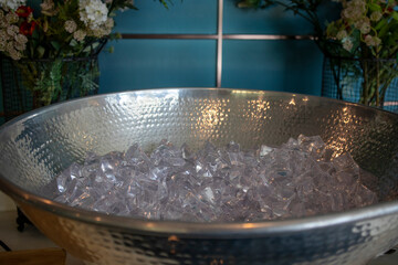 Ice bucket full with crushed ice from top view. Catering set-up ready for the event concept.