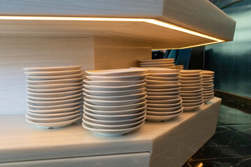 The dishes are stacked on the shelf for customers who come to use in the restaurant. 