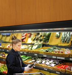 Supermarket shopping,  gloves,woman buying vegetables at the market	