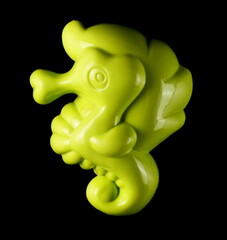 Beach tool toy for kids, green plastic seahorse mold, scoop isolated on black background, top view