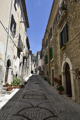 Fototapeta na wymiar A narrow street in the old buildings of San Donato Val di Comino, a medieval village in the Lazio region. 