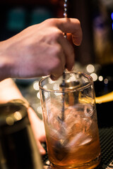 Barman's hand preparing a cocktail