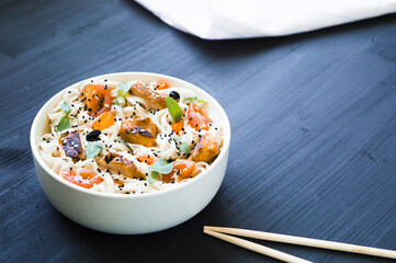 Homemade udon with grilled turkey breast, tomatoes, red hot chili pepper, basil and black and white sesame seeds