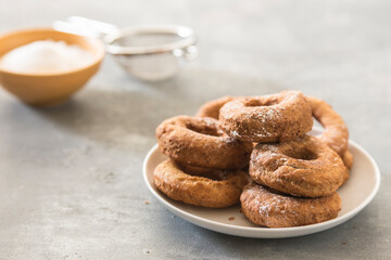 Homemade donuts sugar glazed on a stone background
