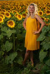 Young attractive woman in a sunflower field