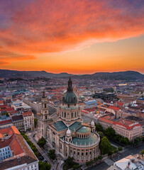Fototapeta na wymiar Budapest, Hungary - Aerial panoramic skyline view of St. Stephen's Basilica with an amazing colorful sunset and Parliament building, Fisherman's Bastion, Buda Hills at background