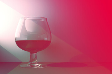 glass of red liquid is illuminated by ray of light