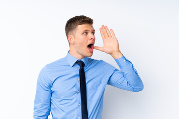 Young handsome businessman shouting with mouth wide open